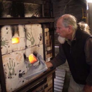 Glenn Burris checks his kiln